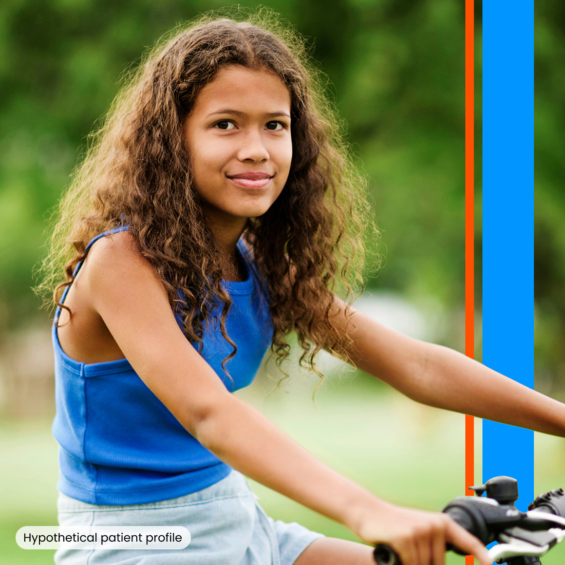 A young girl riding her bike and smiling