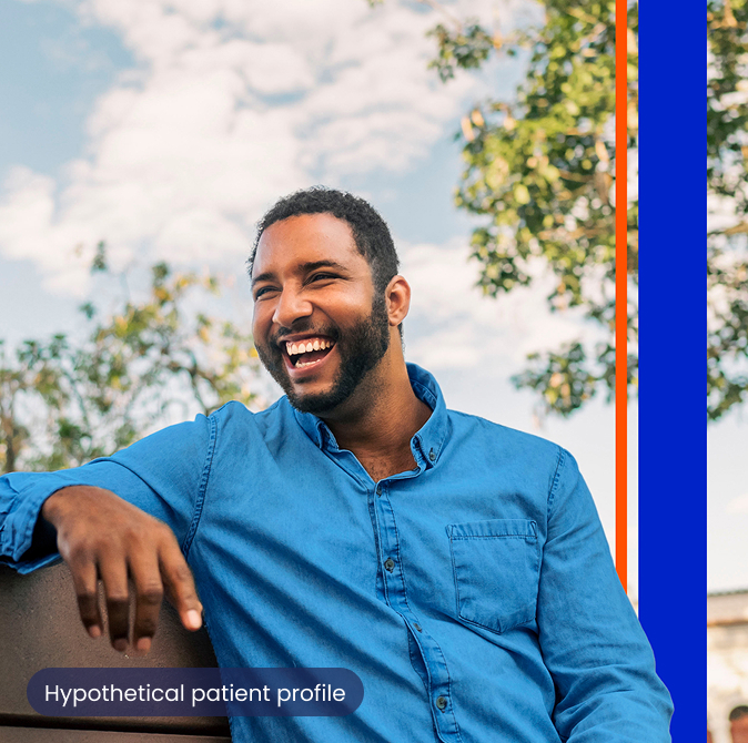 A man sitting on a bench and laughing
