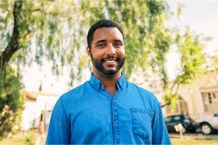 A man smiling outdoors