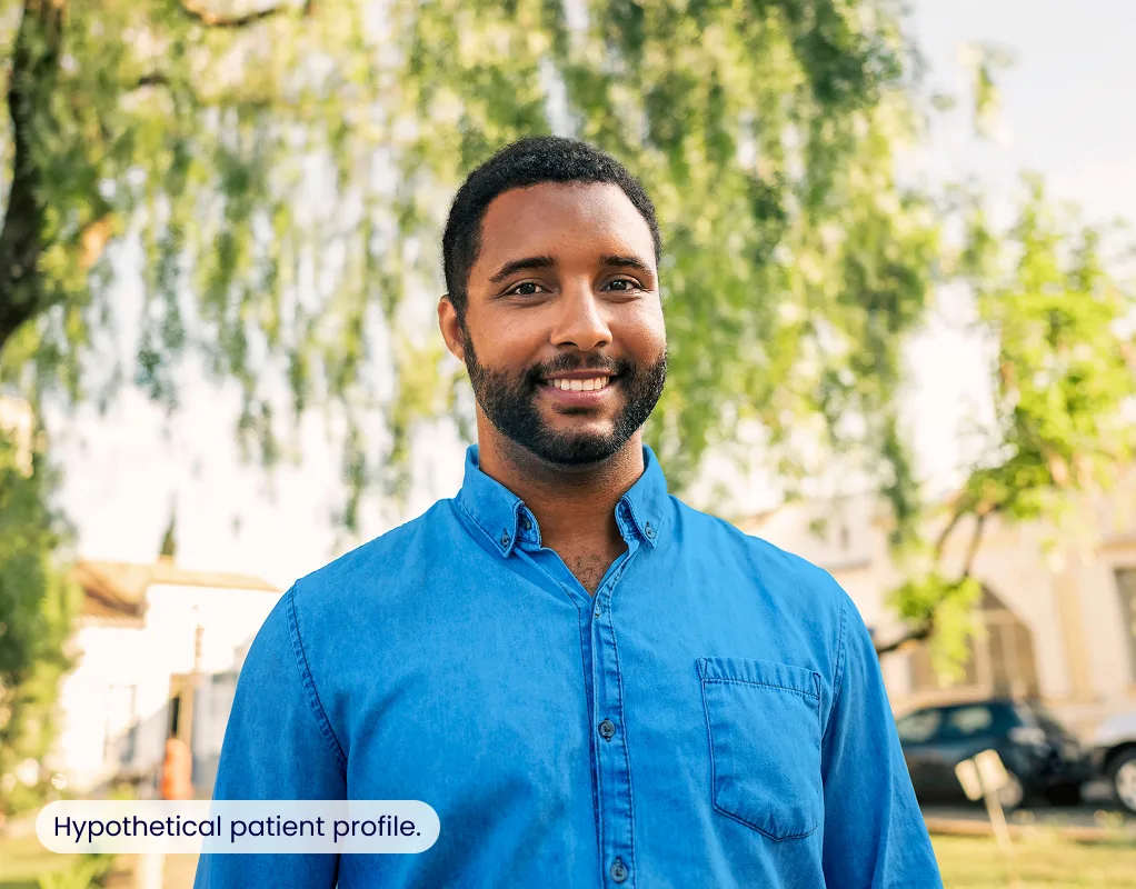A man smiling outdoors